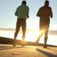 Two people running at sunrise